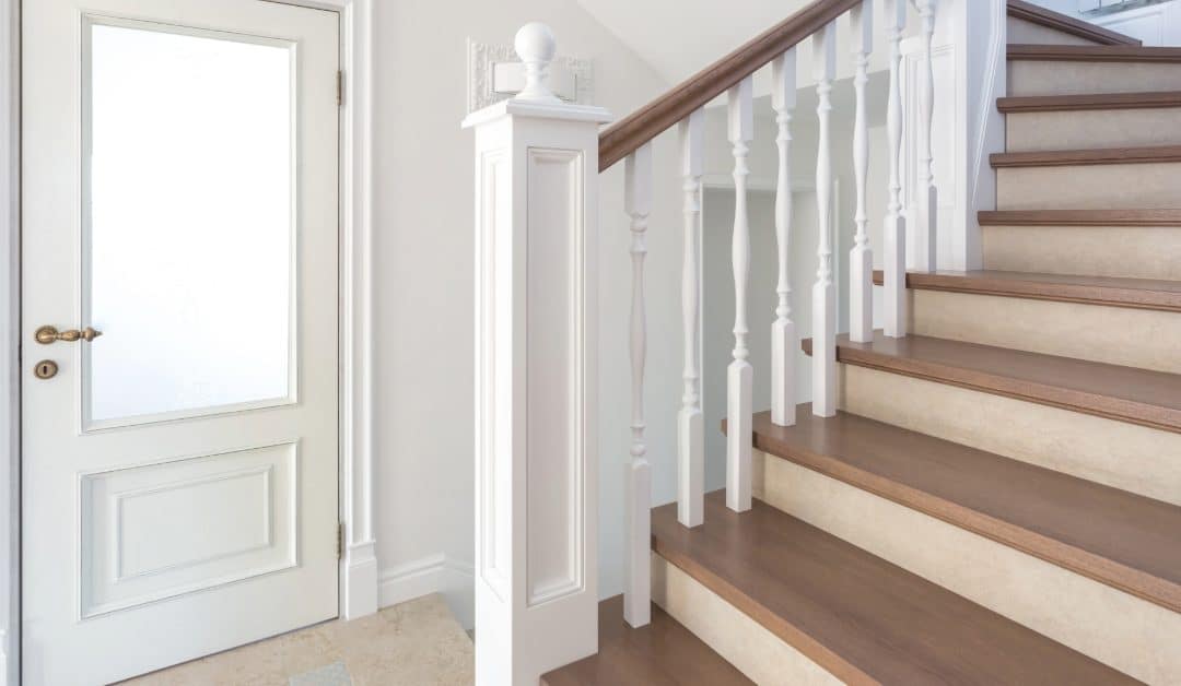 White internal door with frosted glass beside wooden staircase and white balustrade. Bespoke Internal Joinery North East. fitted joinery for period homes