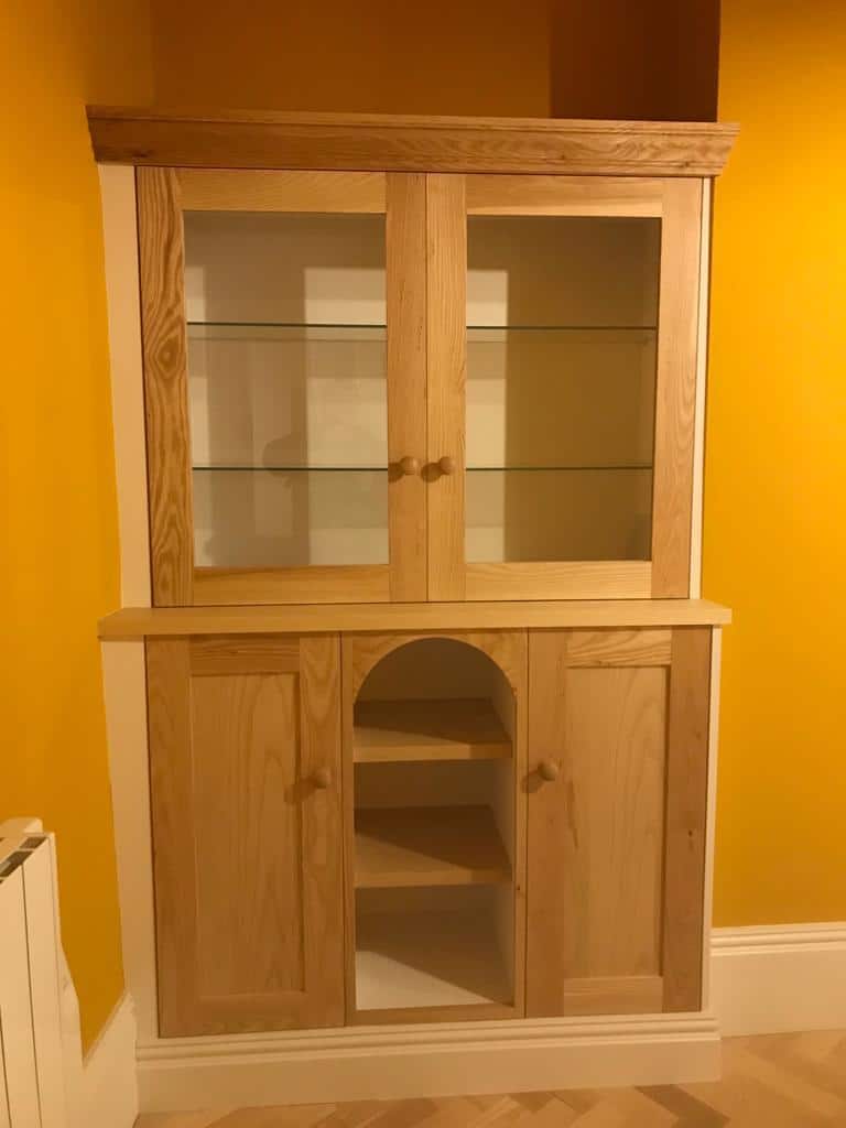 Bespoke fitted bookcase designed to match period joinery and room proportions.